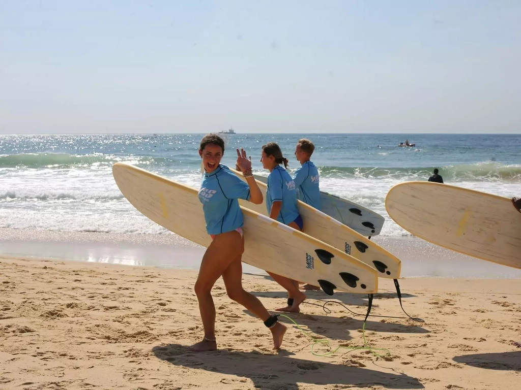 Surfers running to the water