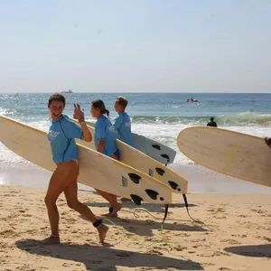 Surfers running to the water