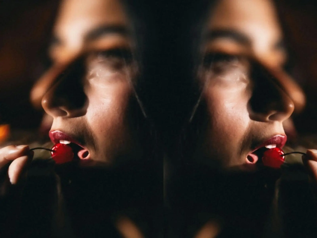 Close up editorial shot of a model with a cherry