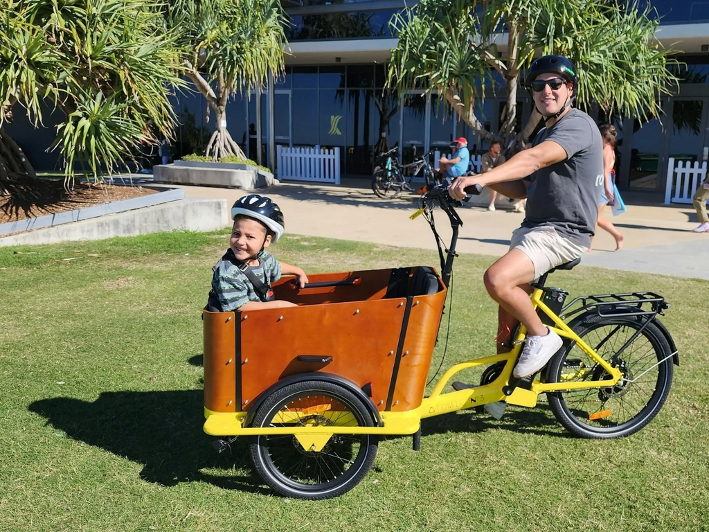 Father and son riding a Tribeca family cargo E-Trike rental in Broadbeach, Gold Coast