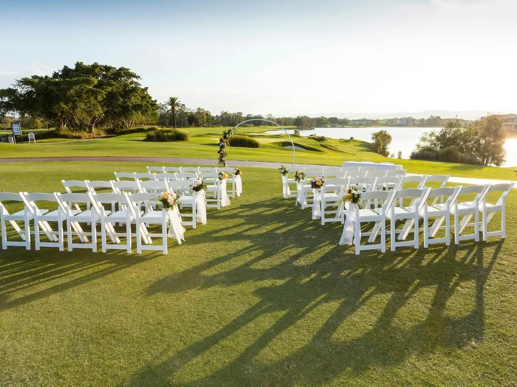 Chairs set up on the golf course facing the 18th hole