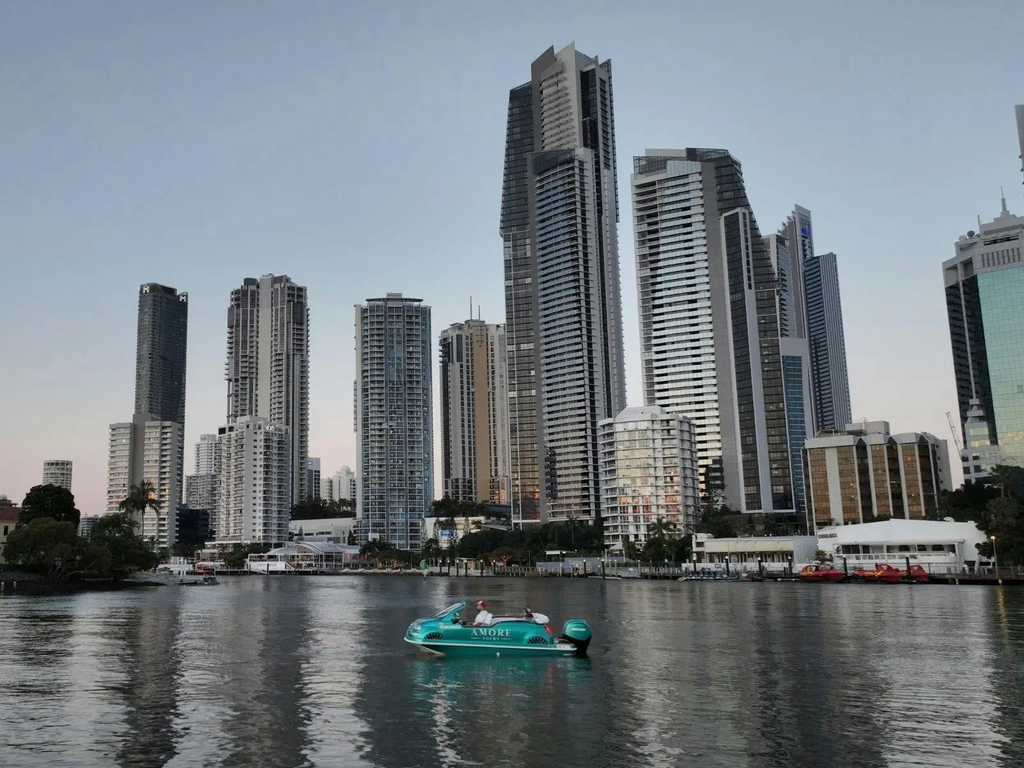 Fiat 500 boat gliding across the Broadwater with the stunning Gold Coast skyline in the background