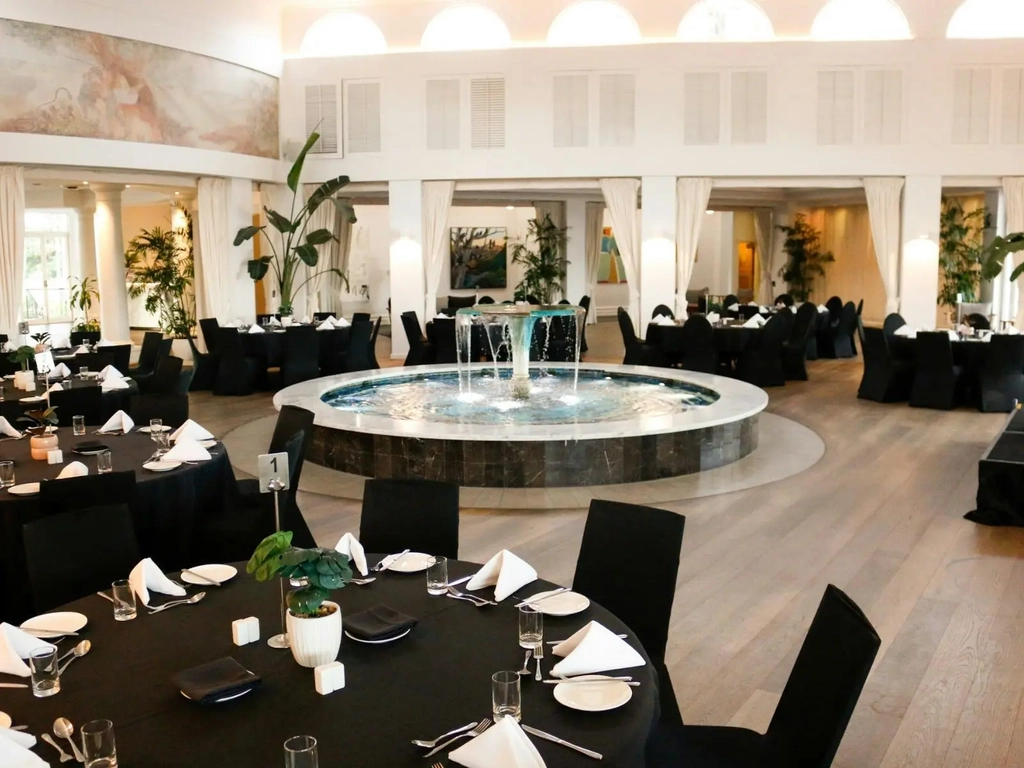 Conference set up with pens, writing pads, water in the Fountain Court