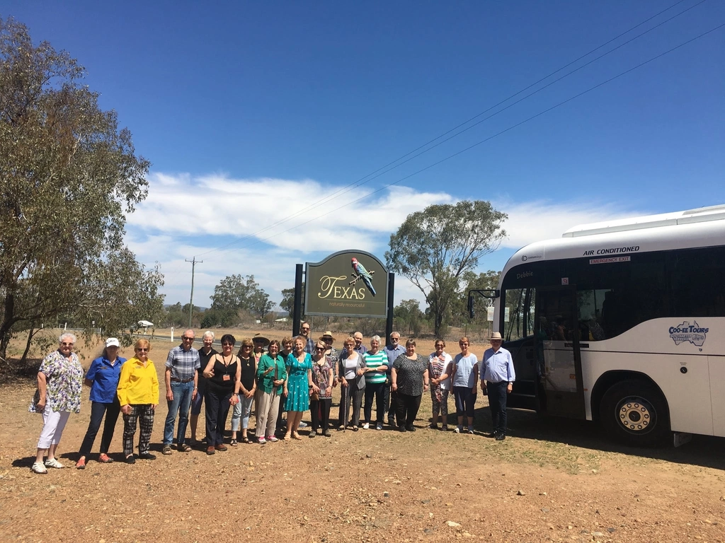 A group of singers arriving on our Cooee Tours coach to entertain locals