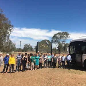 A group of singers arriving on our Cooee Tours coach to entertain locals