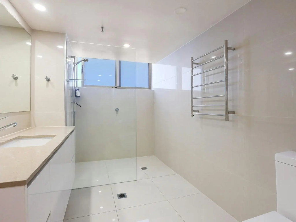 Shared bathroom with vanity, Shower, washing machine and dryer