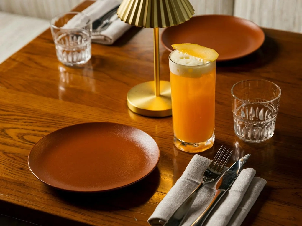 Cocktail on table with tableware