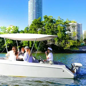 Group of guests relaxing aboard a self-drive GoBoat with Gold Coast skyline views in the background.