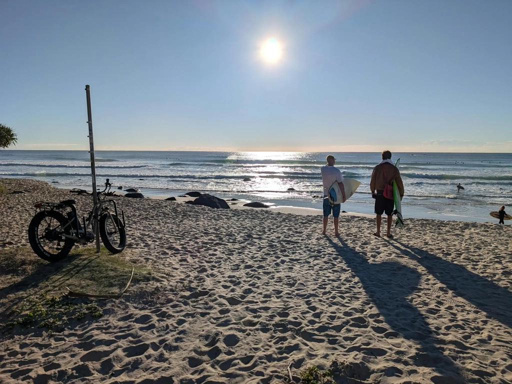 A photo of two surfers surveying the surf