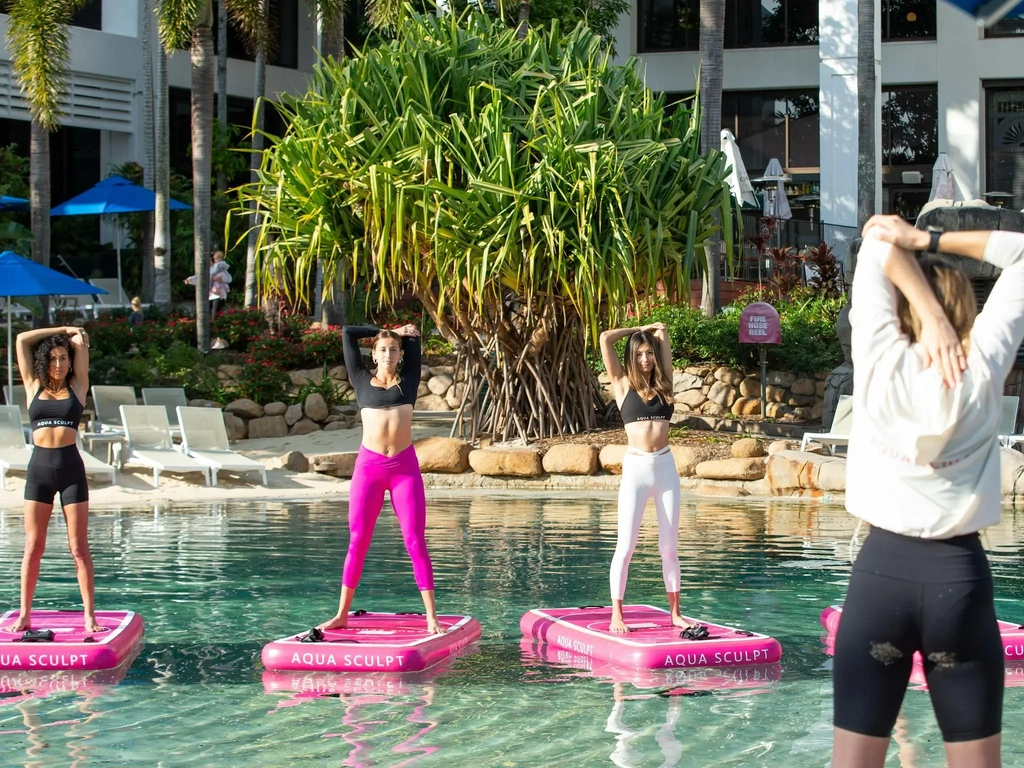 Participants standing on the boards doing arm stretches