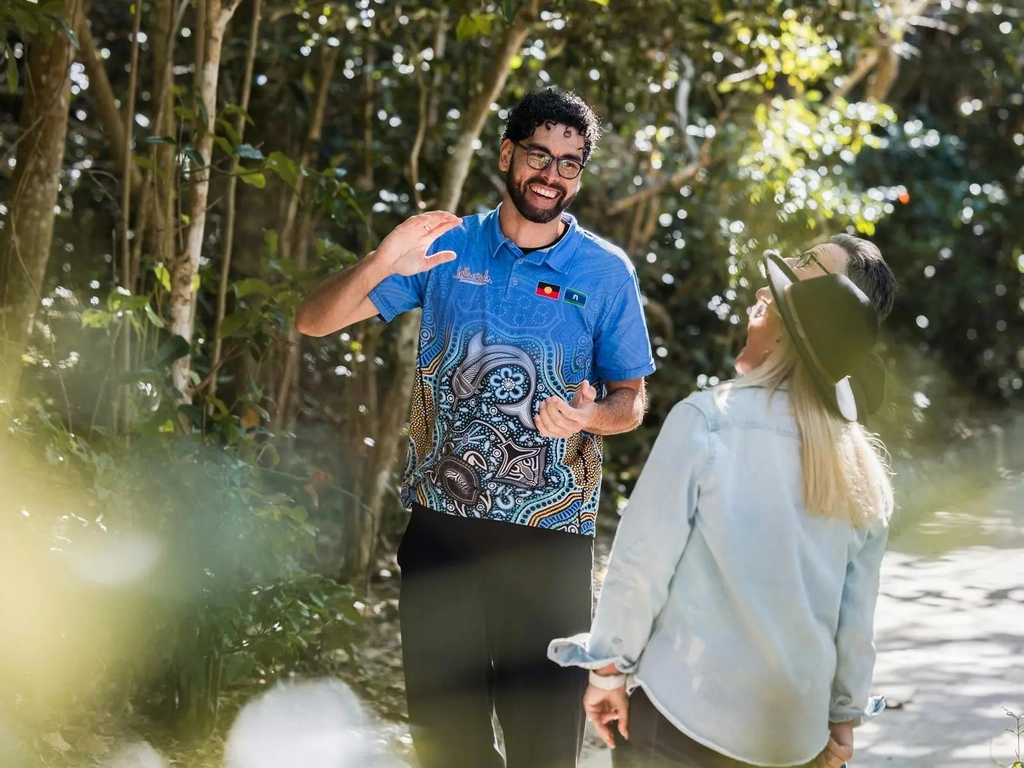 A Jellurgal Guide explains traditional uses of plants during a Jellurgal Walkabout Tour