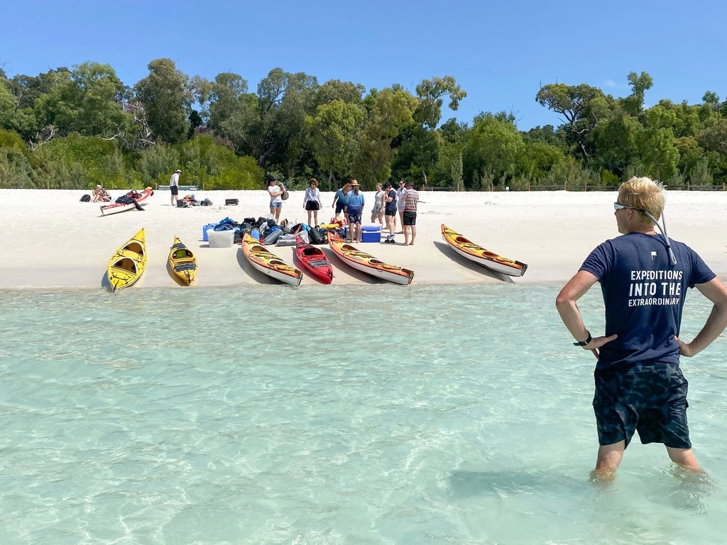 kayaks and paddlers on the white sandy beaches of the Whitsundays