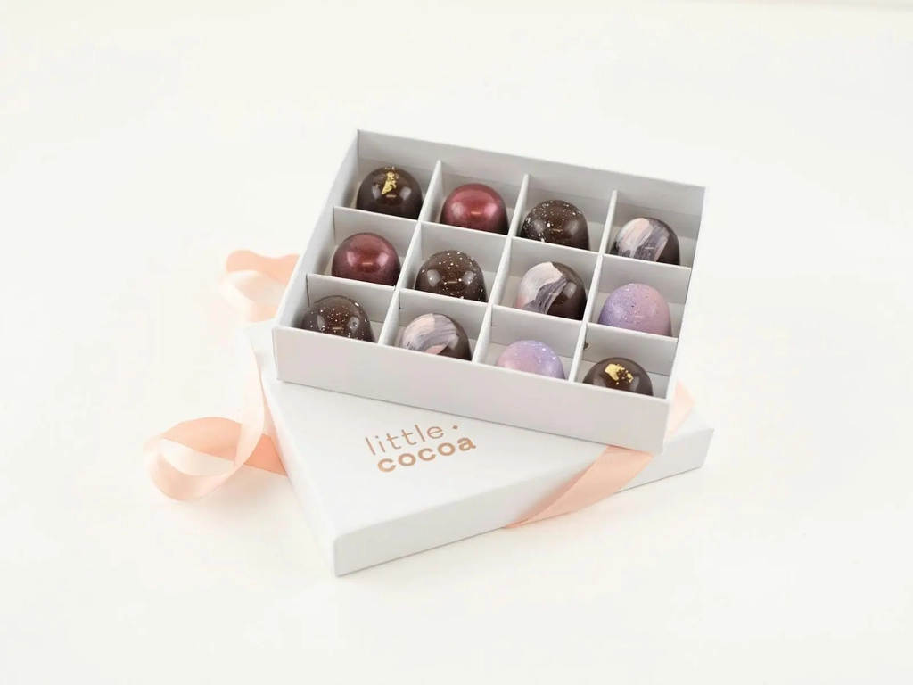 Open box of chocolates with ribbon