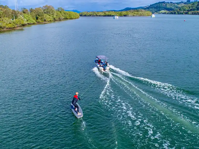 A Foiling Australia student learning how to foil tow behing a boat on Nerang River