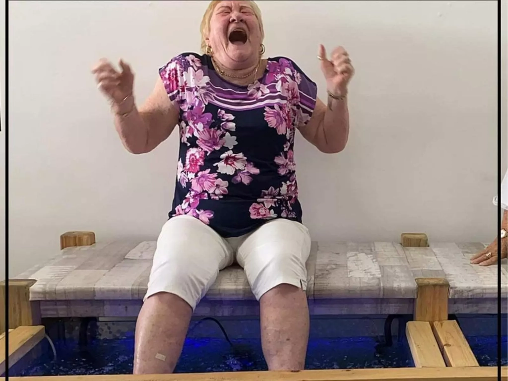 A lady having a fish spa at Barefoot Fish