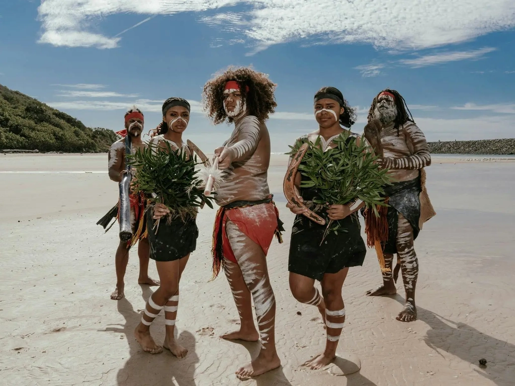 The Yugambeh Aboriginal Dancers perform on the beach during a Jellurgal Walkabout Tour