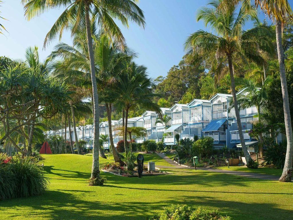 Villas lined up amongst palm trees