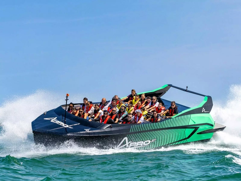 Guests on black and green Arro Jet Boat.