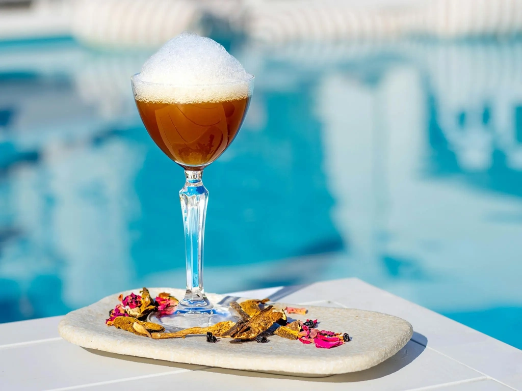 Poolside cocktail at La Luna Beach Club overlooking the marina