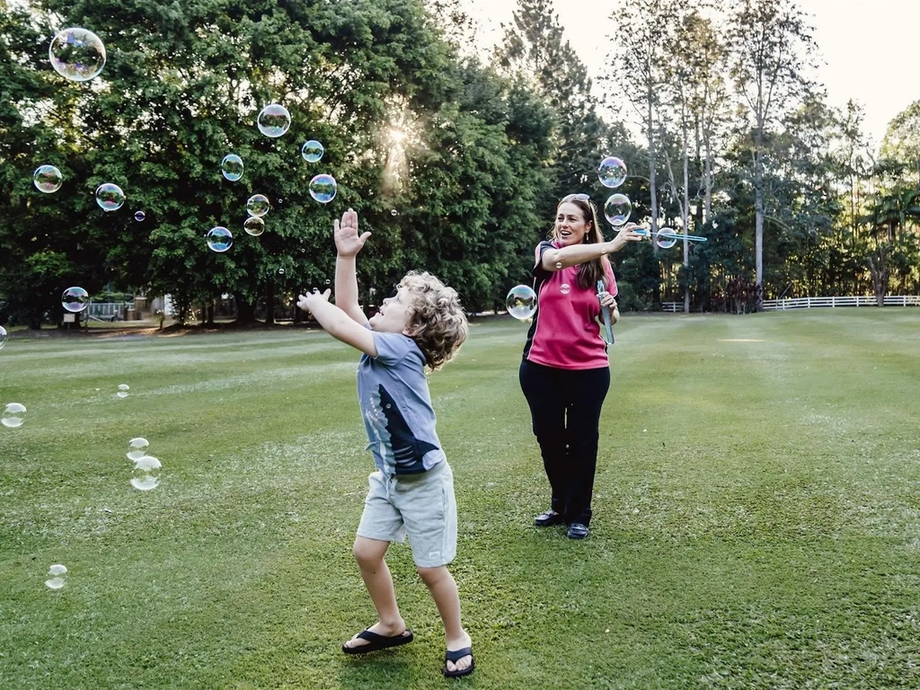 Coastal Babysitter playing with bubbles