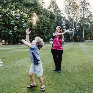 Coastal Babysitter playing with bubbles