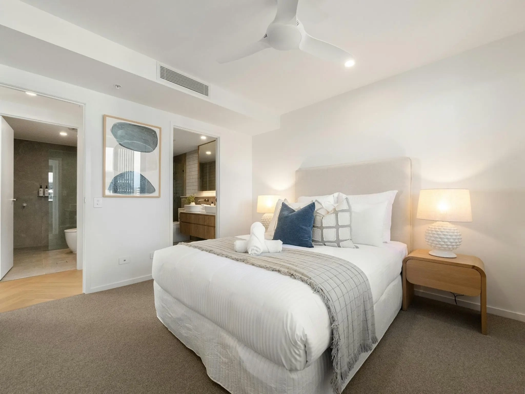 Main bedroom with king bed and doorway through to the ensuite