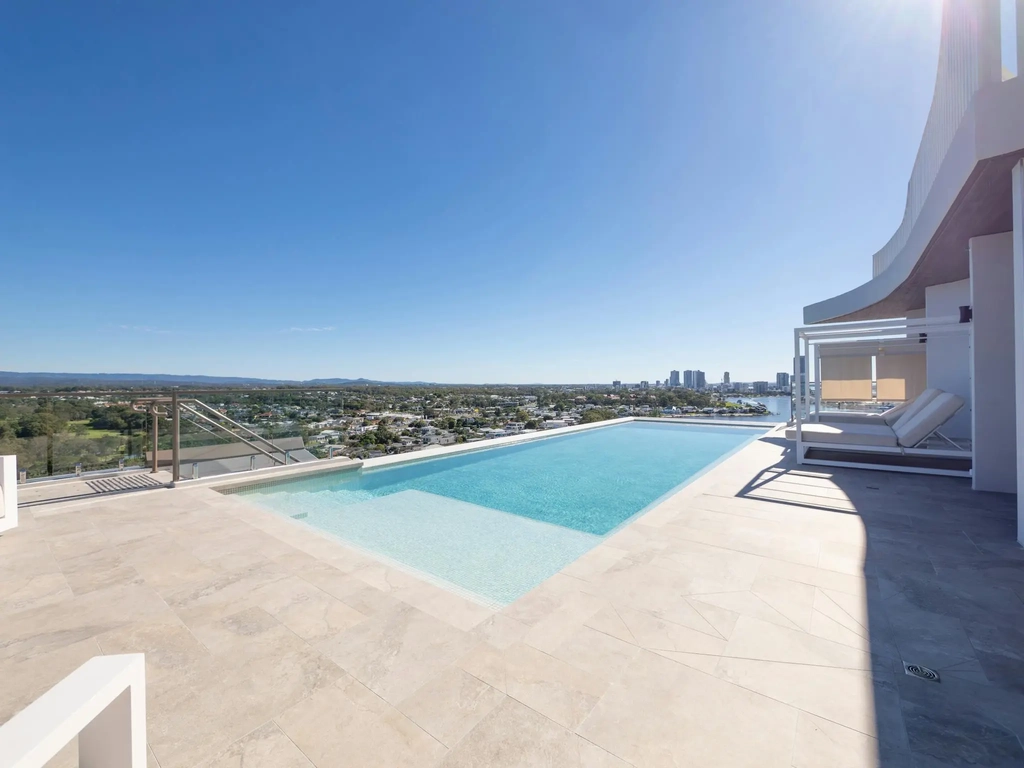 Rooftop infinity pool and terrace with city and water views