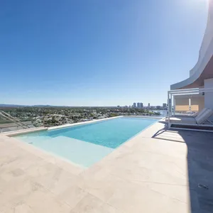 Rooftop infinity pool and terrace with city and water views