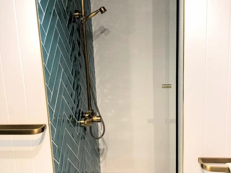 Shower with tiles and brass fittings