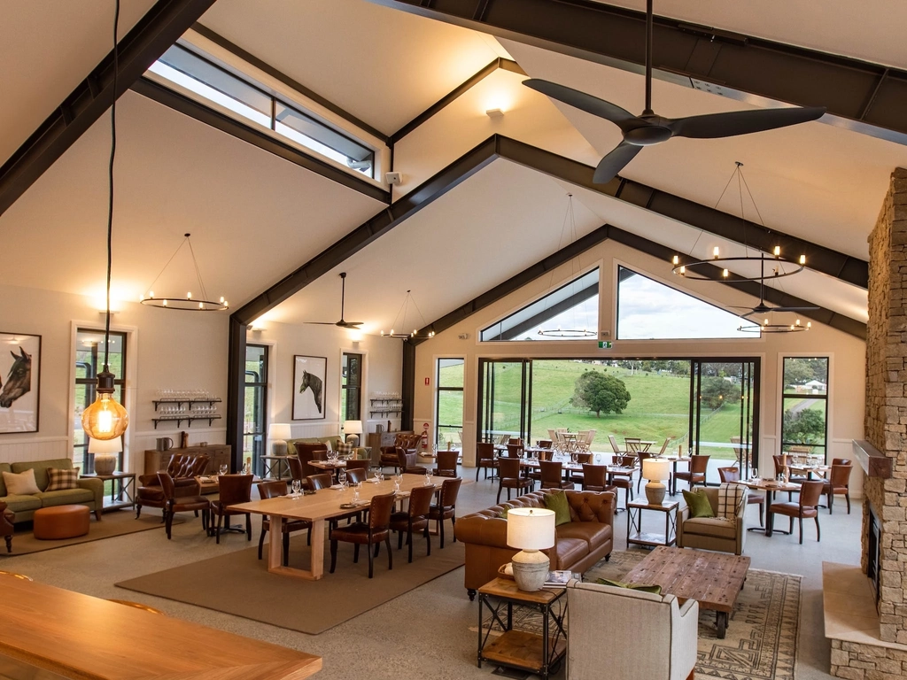 The Paddock restaurant interior featuring floor-to-ceiling windows that maximise hinterland views
