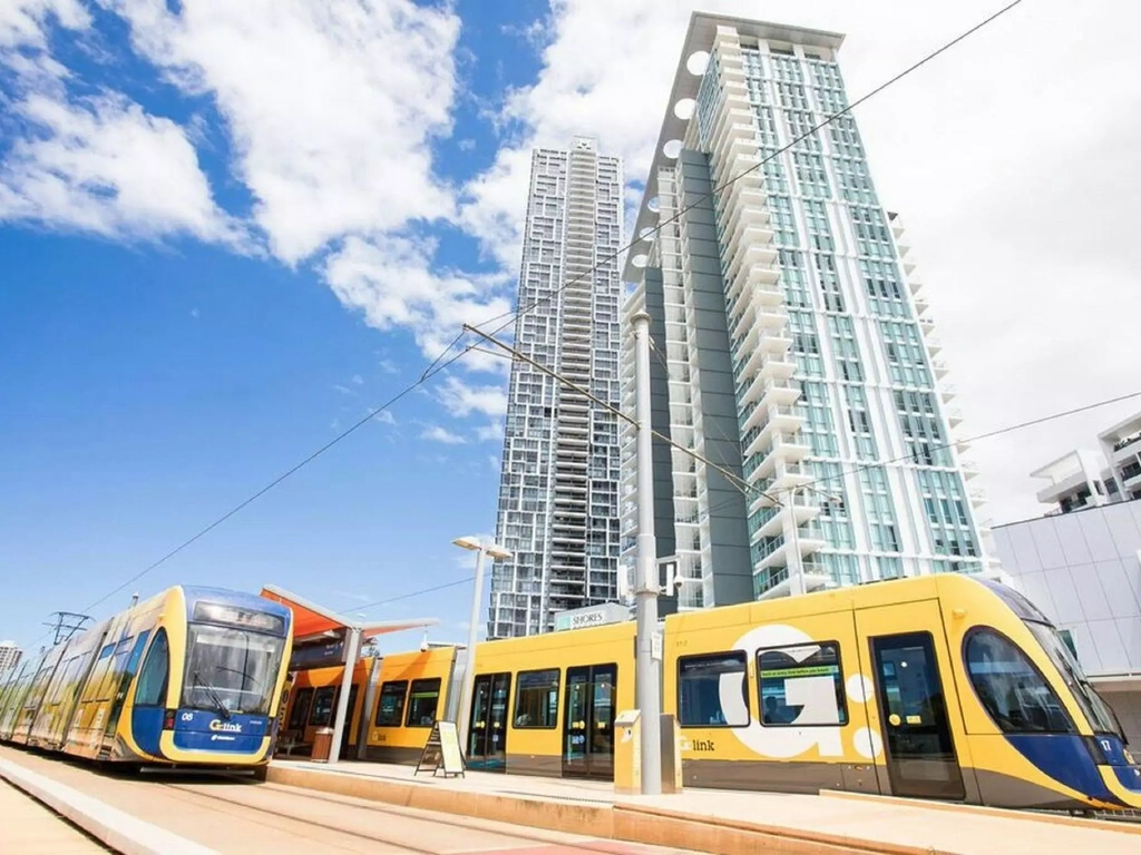 Train Station is located at the door of the building, photo shows both train and Brighton Shores