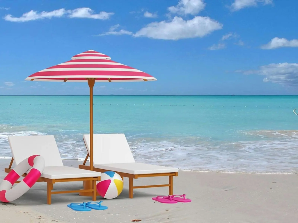 two deckchirs and a sun umbrella on the beach