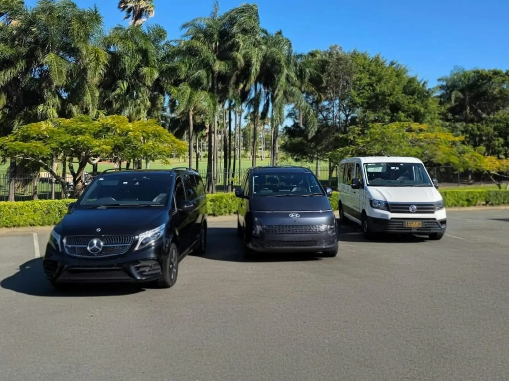 GEC Transfers fleet featuring Mercedes-Benz, Hyundai Staria, and Volkswagen vans lined up outdoors.