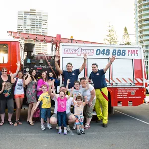 Families posing for photos beside the Fire Trucks with their Fire Fighters