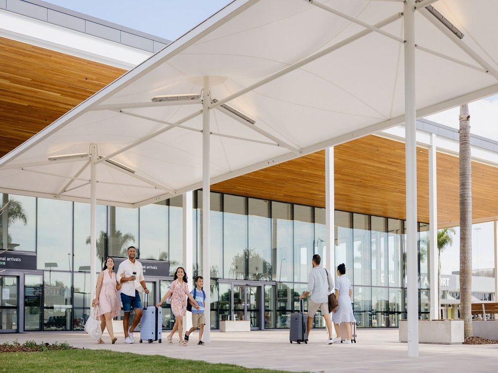 Family arriving to the Gold Coast Airport walking out into international arrivals plaza