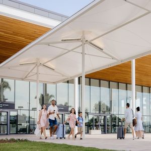 Family arriving to the Gold Coast Airport walking out into international arrivals plaza