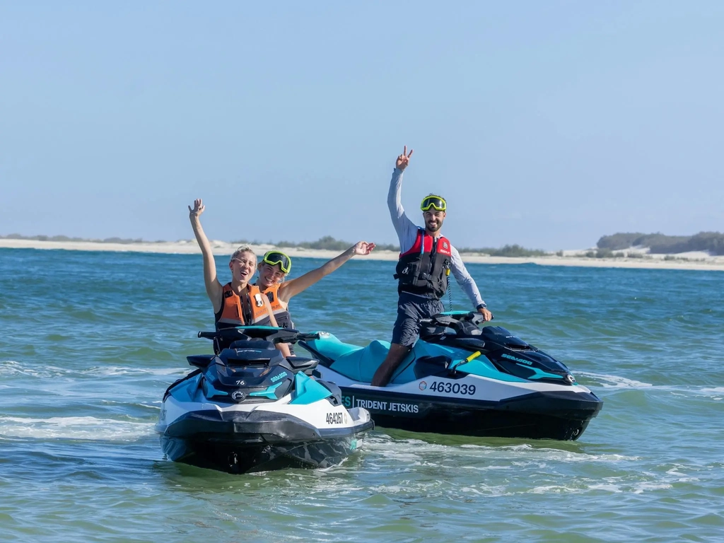 Happy people on Jetskis exploring South Stradbroke Island