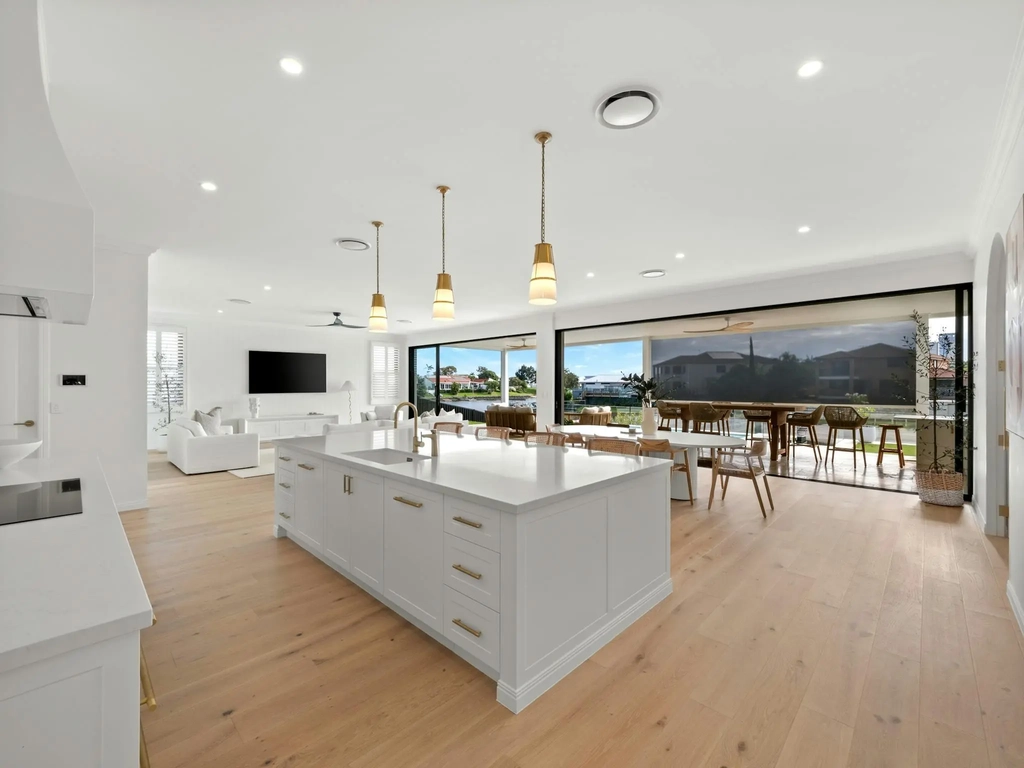 Kitchen with stone island bench facing the water