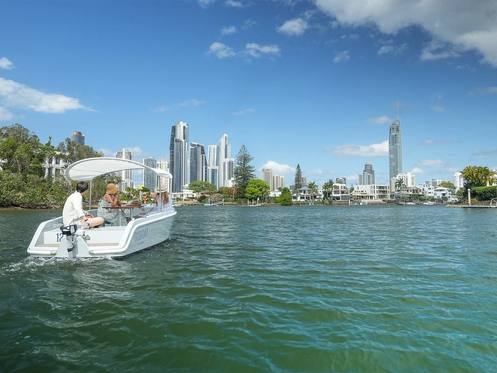 A GoBoat sails on the Nerang River, looking towards Surfers Paradise.