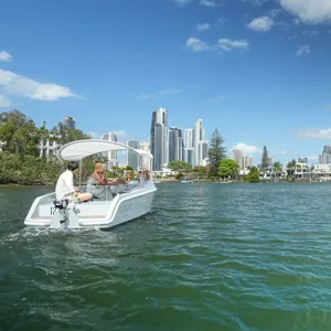 A GoBoat sails on the Nerang River, looking towards Surfers Paradise.