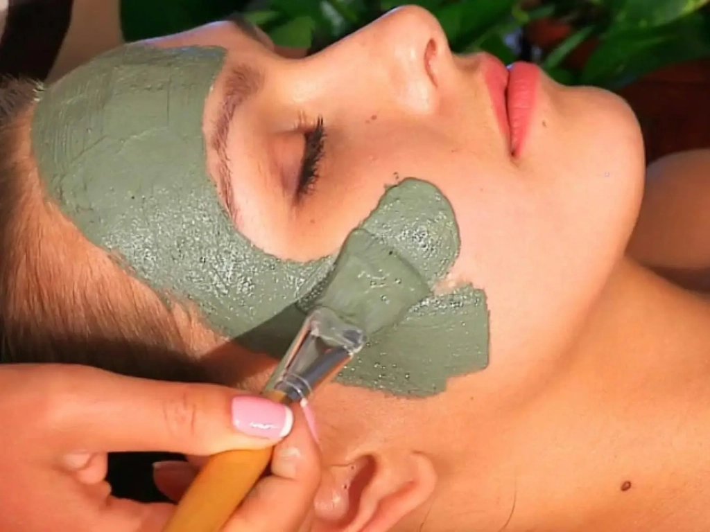 Woman having  a green clay mask as part of day spa package on the Gold Coast