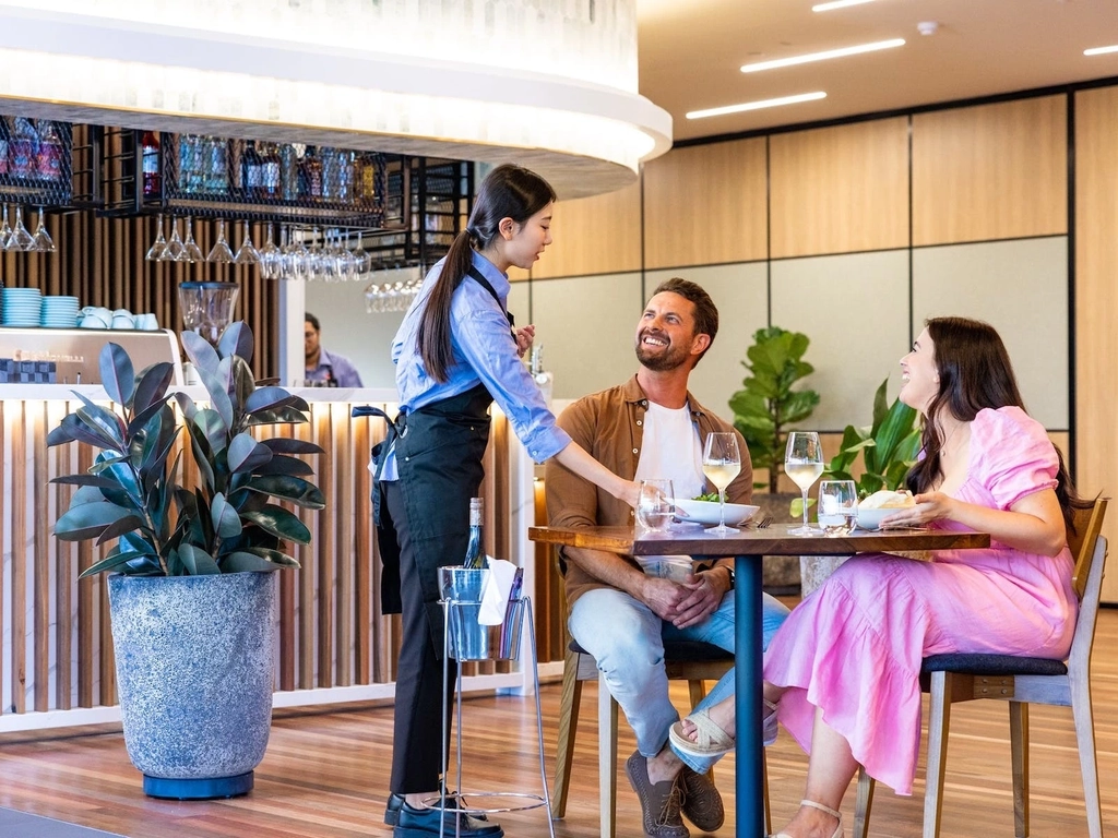 Couple enjoying enjoying dinner in restaurant being served