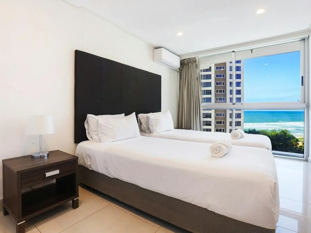 Second bedroom with 2 single beds, ocean views, tile floors - Gold Coast Holidays Surfers Paradise
