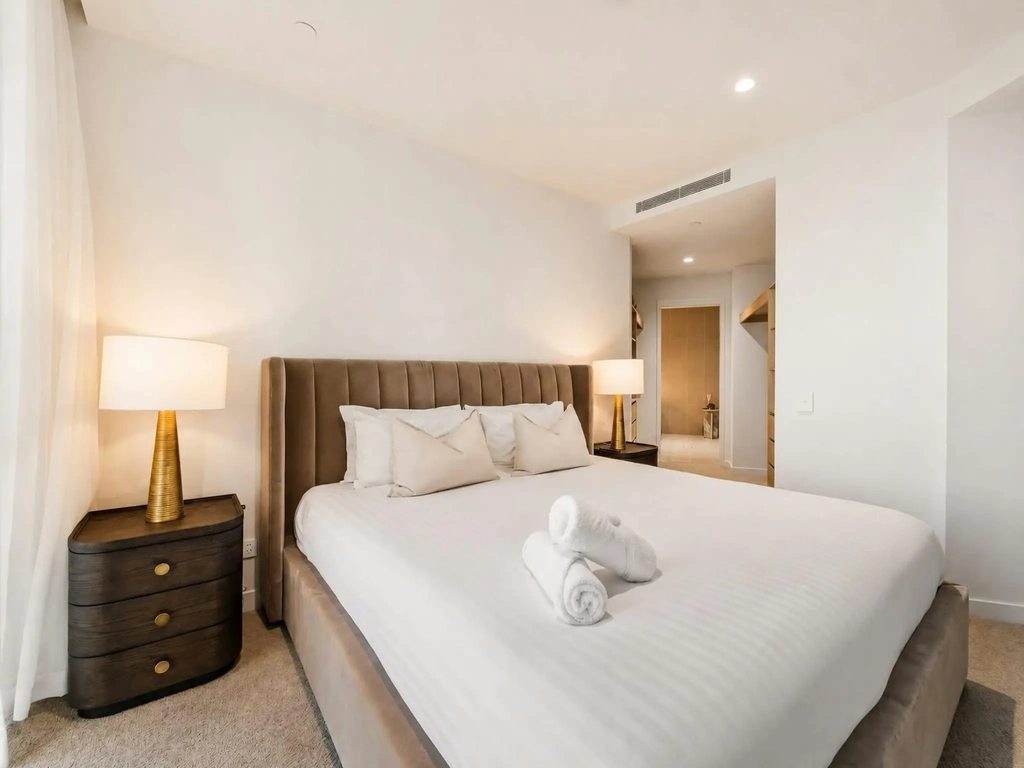 Second bedroom with a large bed and an ensuite bathroom