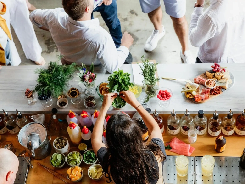 Staff preparing tastings, cocktails, and cheese boards for guests at the cellar door experience.