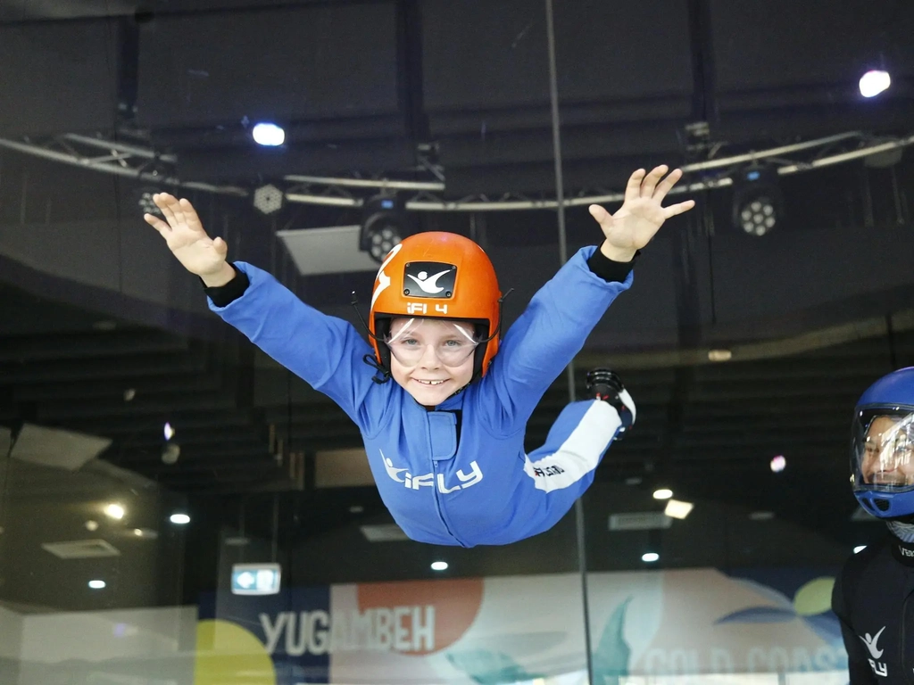 Small boy flies unassited in a blue suit