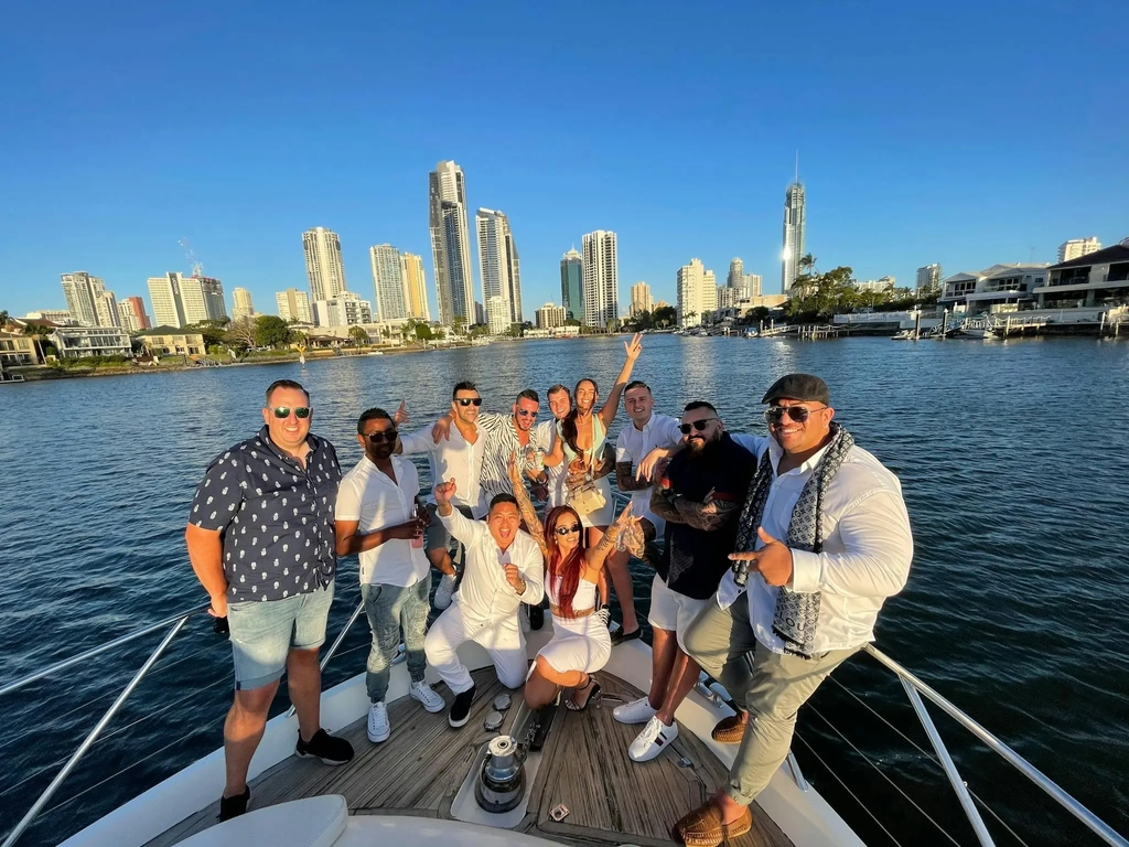 Group of women enjoying a private yacht celebration with city views in the background on a sunny day