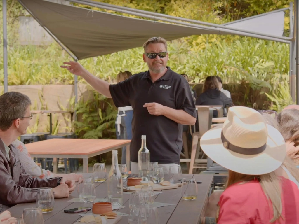 South East Discovery Tours host, PJ, presenting wine to the group