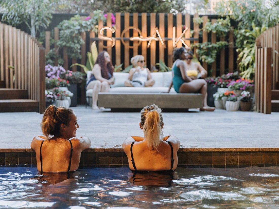 Connect with friends in the warm mineral pools at Soak Bathhouse Mermaid Beach