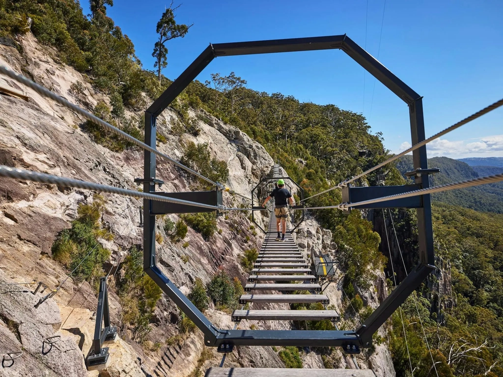 Man walking across Via Ferrata at Happitat Adventure Park
